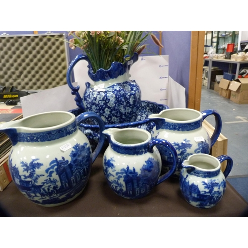 72 - Reproduction blue and white ceramic toilet ewer and basin, and a set of reproduction graduated jugs.