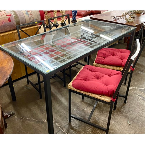 539 - Contemporary steel framed grid design glass topped dining table with four chairs 76cm h