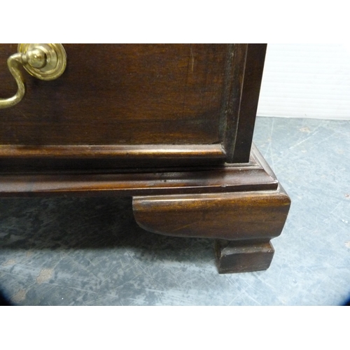 557 - Reproduction chest of four drawers on bracket feet.