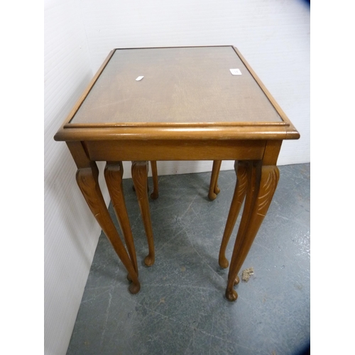 564 - Nest of three mahogany tables with inset glass tops.