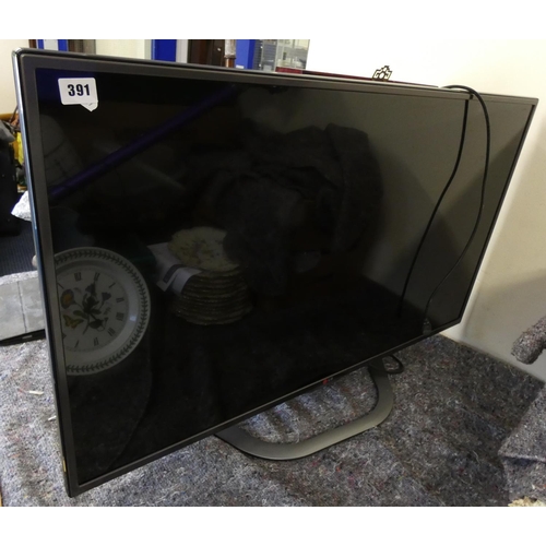 391 - Large modern LG flat screen TV & remote.