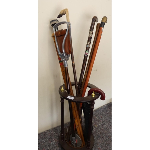 477 - Stick stand containing a collection of walking sticks