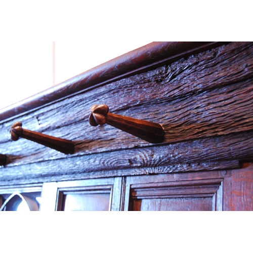 376 - English Arts & Crafts oak hallstand, with naturalistic cornice and five ornate pegs above a Goth... 