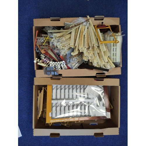 378 - Two boxes of model railway components to include windows and railings etc. (2)