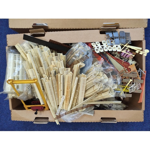 378 - Two boxes of model railway components to include windows and railings etc. (2)