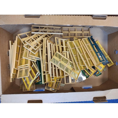 378 - Two boxes of model railway components to include windows and railings etc. (2)