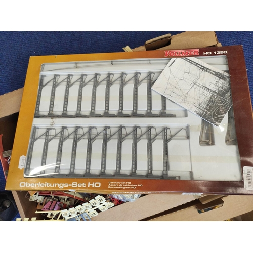 378 - Two boxes of model railway components to include windows and railings etc. (2)