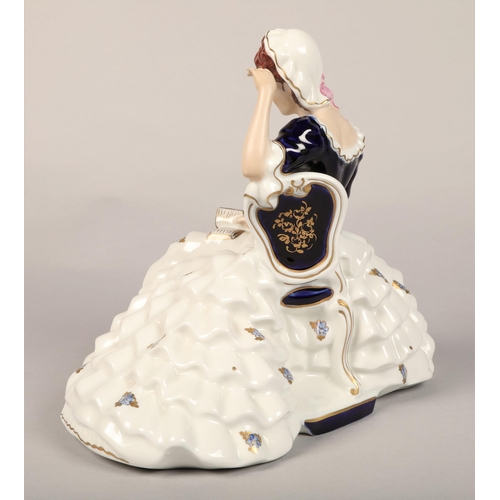 21 - Royal Dux seated lady with a book, pink triangle to base, cobalt blue and gold, approx. 27cm h