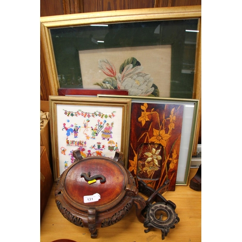 131 - Oriental hardwood screen, a hardwood stand, two framed needle works, a wooden panel, and another.