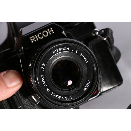 11 - Ricoh KR10 Super SLR camera, with Rikenon 1:2 50mm lens, a boxed Brownie, and other accessories.