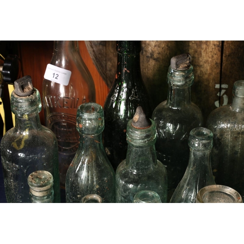 12 - Vintage glass bottles to include a torpedo shaped bottle for Schweppes, Aitken of Dunbar, Hendry's L... 