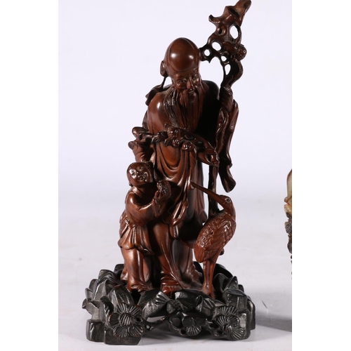 246 - Chinese soapstone carving of a male figure, 16cm high, and a Chinese wood carved figure group, 20cm ... 