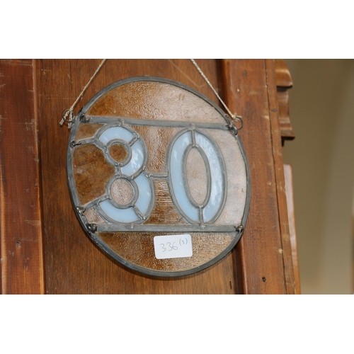 336 - Stained leaded glass panel, 45 x 30cm, a wall mirror with relief flower, 27 x 37cm, and a number 30 ... 