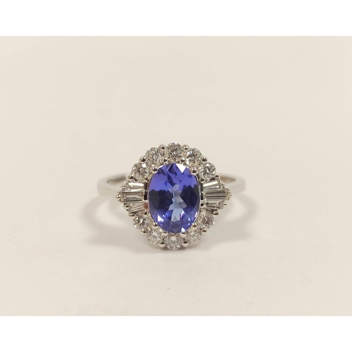 101 - Tanzanite and diamond oval cluster ring, in 18ct white gold, size 'M'.