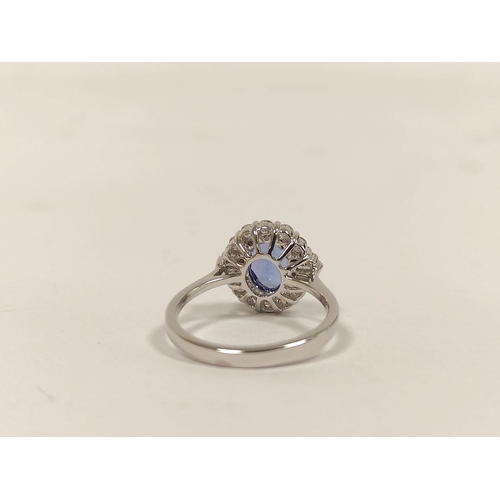 101 - Tanzanite and diamond oval cluster ring, in 18ct white gold, size 'M'.