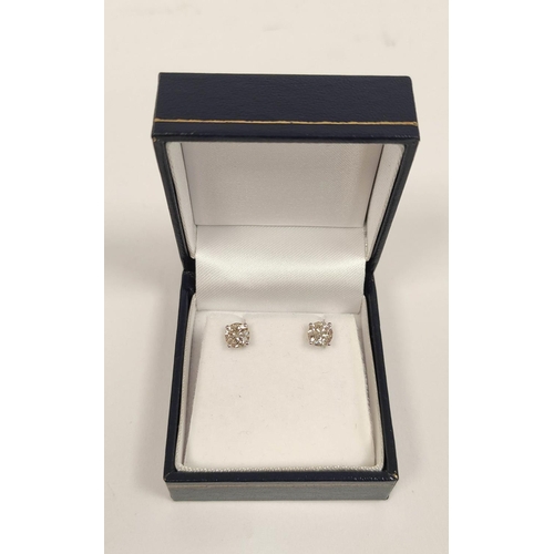 80 - Pair of 18ct gold ear studs, each a single diamond.