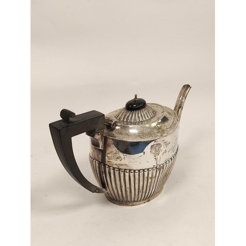 93 - Silver three-piece tea set, part fluted, by Deakins, Birmingham, 1911, also a toast rack, 974g.  (4)