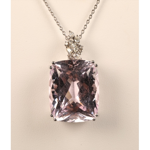 105 - 18ct marked white gold diamond and large pink stone set pendant on white metal chain