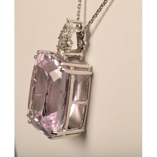 105 - 18ct marked white gold diamond and large pink stone set pendant on white metal chain