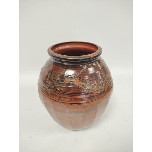 342 - Oriental treacle glazed jar in the Chinese Ming style with relief all-over panel of five claw dragon... 