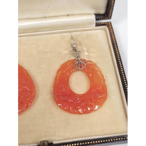 114 - Pair of orange jade drop earrings of almost circular shape, in white gold (uncertified).