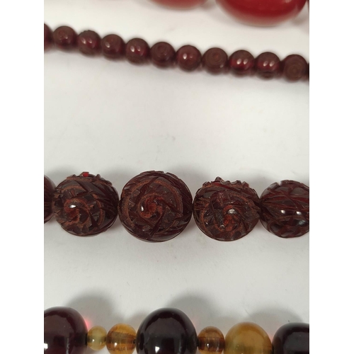 133 - Three amber necklets and a similar bracelet, part, gross 142g.  (4).