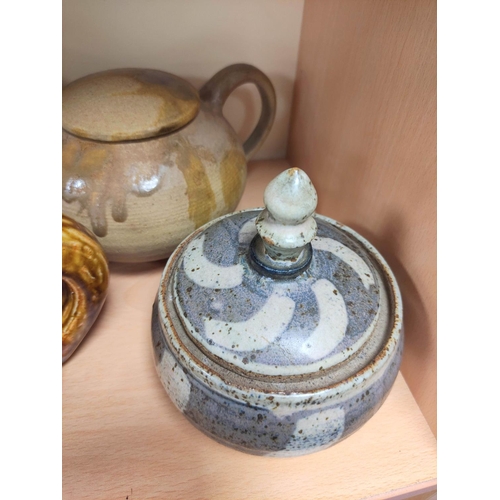 345 - Chinese and Oriental stoneware and clay tea pots to include a brown glazed example with bamboo handl... 