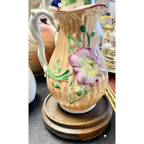 296 - Large decorated stoneware jug, three others, leaf decorated vase and a hardwood stand