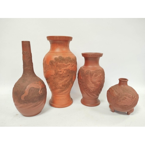 340 - Four Oriental terracotta vases of baluster form and bottle shape, all bearing relief dragon decorati... 