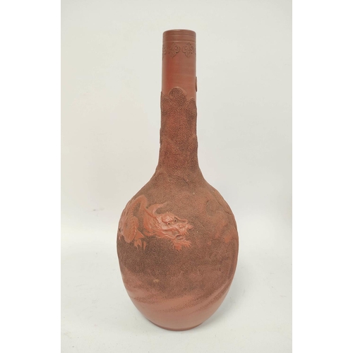 340 - Four Oriental terracotta vases of baluster form and bottle shape, all bearing relief dragon decorati... 