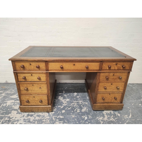 382 - Oak pedestal desk with turned knobs, tooled leather top and long drawer, flanked by four short drawe... 