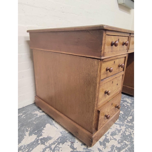 382 - Oak pedestal desk with turned knobs, tooled leather top and long drawer, flanked by four short drawe... 