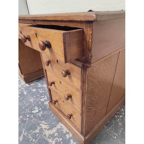 382 - Oak pedestal desk with turned knobs, tooled leather top and long drawer, flanked by four short drawe... 