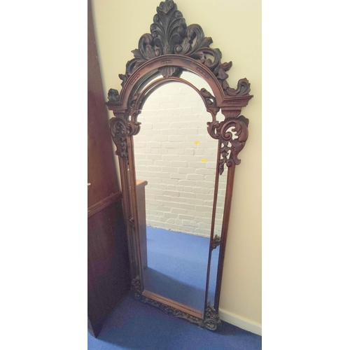 388 - Mahogany fret wall mirror, with scrolled carved frame, the arched top with feather surmount, 189cm h... 