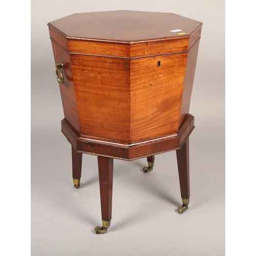 624 - George III mahogany octagonal cellarette raised on tapering supports on brass casters (need repair) ... 