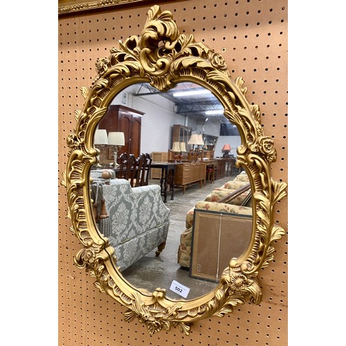 502 - Oval gilt wall mirror, 47 x 63 cm with another smaller (2)