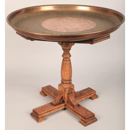 513 - Hammered copper tray (46cm d) on small oak coffee table