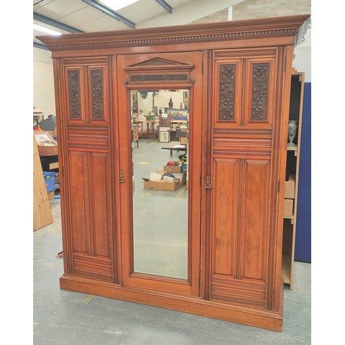 392 - Late Victorian mahogany triple wardrobe with large central mirror flanked by carved floral panel doo... 