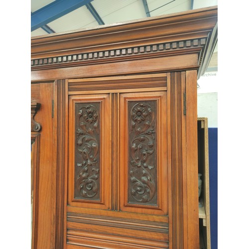 392 - Late Victorian mahogany triple wardrobe with large central mirror flanked by carved floral panel doo... 