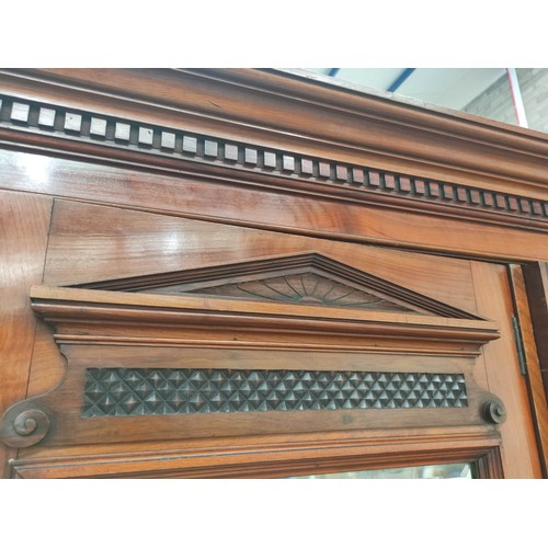 392 - Late Victorian mahogany triple wardrobe with large central mirror flanked by carved floral panel doo... 