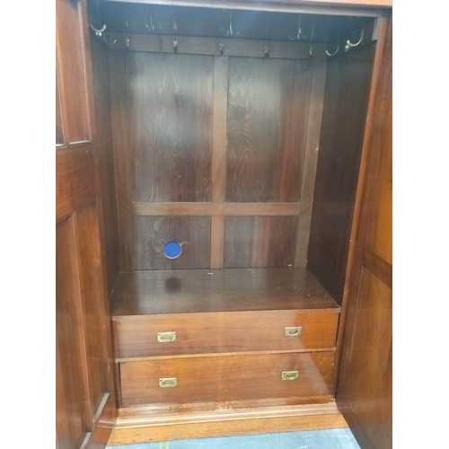 392 - Late Victorian mahogany triple wardrobe with large central mirror flanked by carved floral panel doo... 