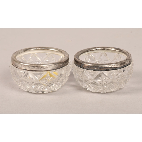 167 - Pair silver rimmed cut glass table salts, pair silver shell salt spoons, pair silver and mother of p... 