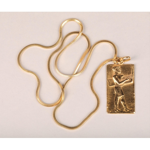 80B - 18ct gold Egyptian pendent with a 18ct gold chain, stamped 750, 33 grams