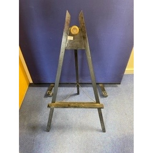 398 - Ebonised easel with brass roundel. 106cms high.