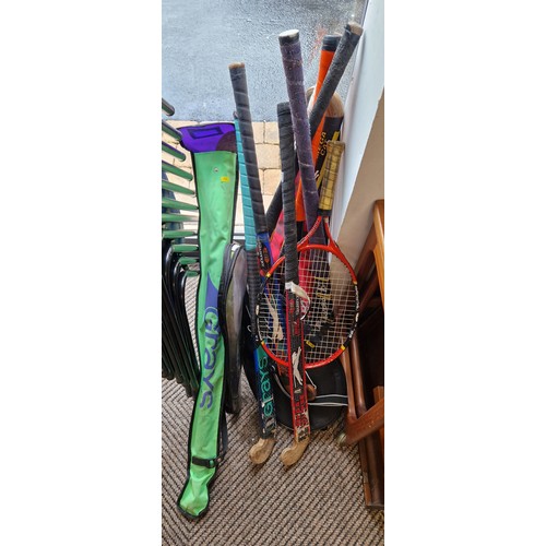 412 - Collection of hockey sticks, tennis rackets etc