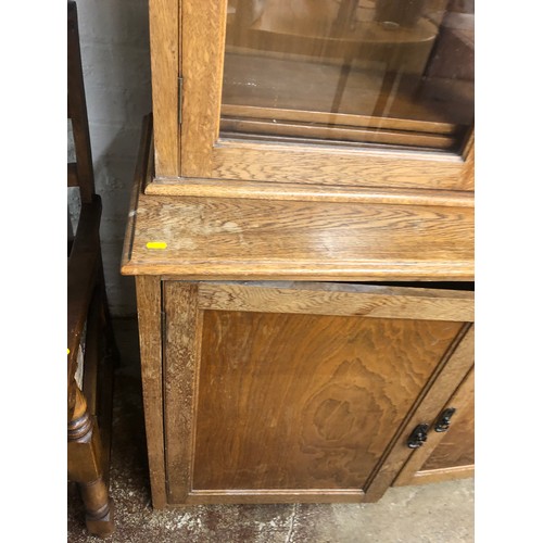 573 - Early 20th century Oak glazed book case over cupboard, 183 x 215 x 46 cm