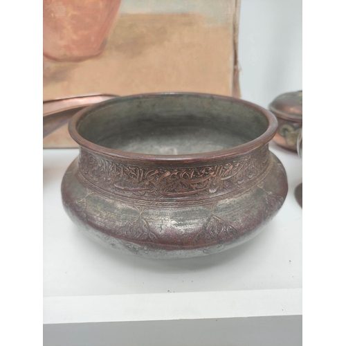 347 - Eastern copper ware, mainly of Indian origin to include vases, a charger decorated with deities in r... 