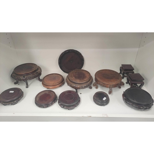 331 - Antique and oriental hardwood stands to include padouk examples. (12)