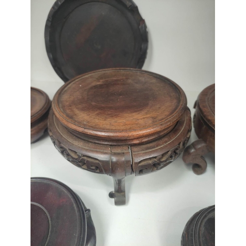 331 - Antique and oriental hardwood stands to include padouk examples. (12)