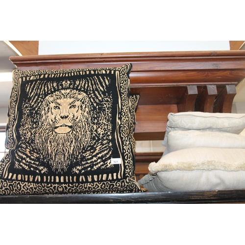 560A - Pair of cushions with lions and leopard print, 59 x 51cm, and three others.